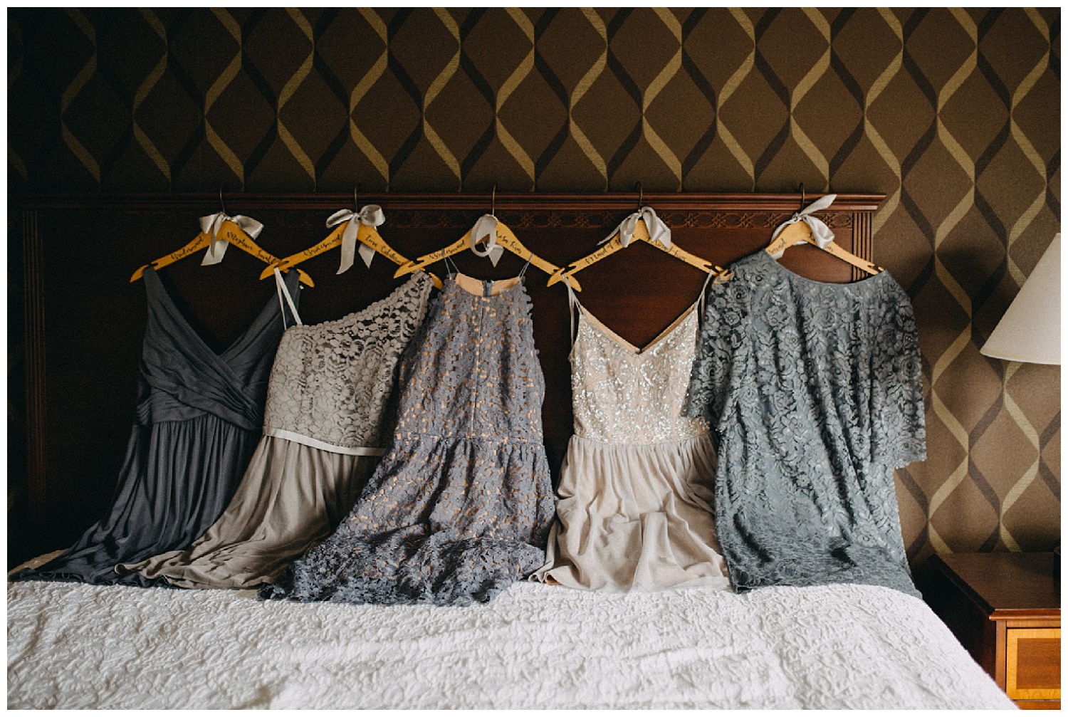 mismatched bridesmaid dresses hung in a row