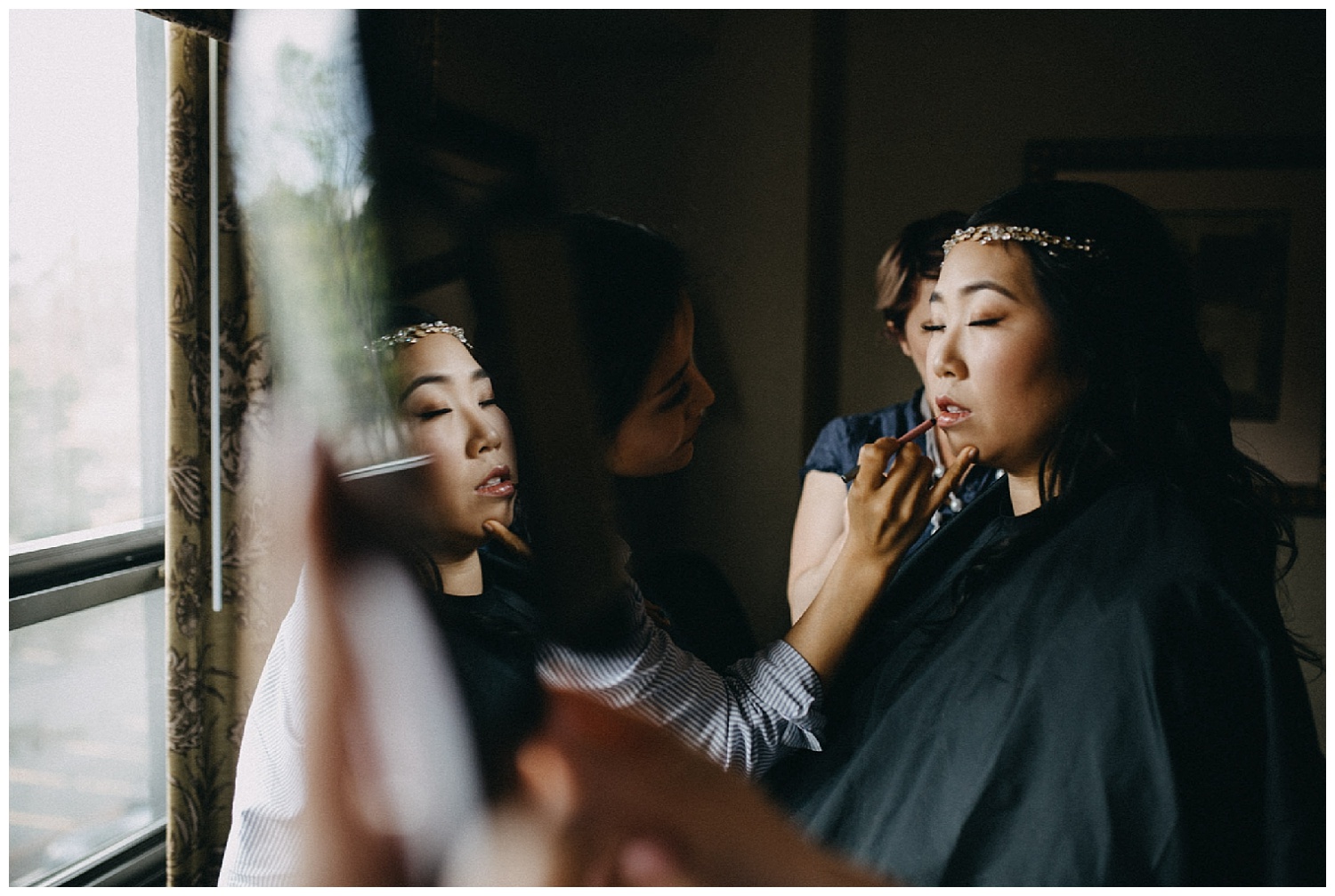 a bride to be puts her lipstick on