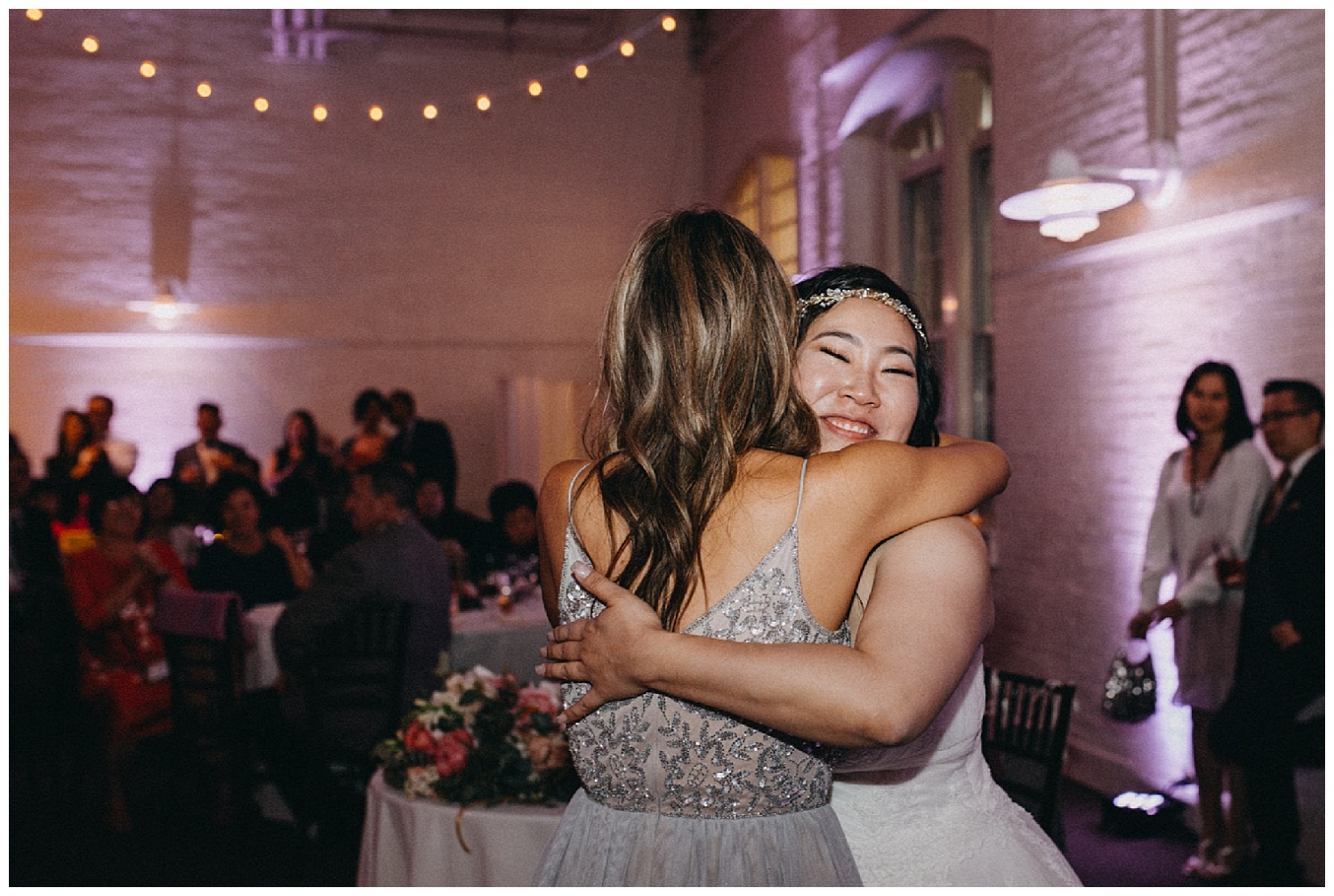 a bride hugs her maid of honor after speeches