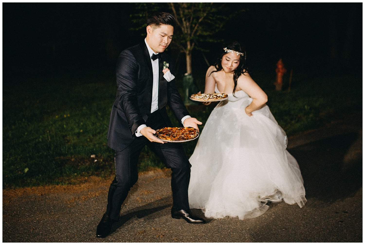 bride and groom enjoy pizza at wedding reception 