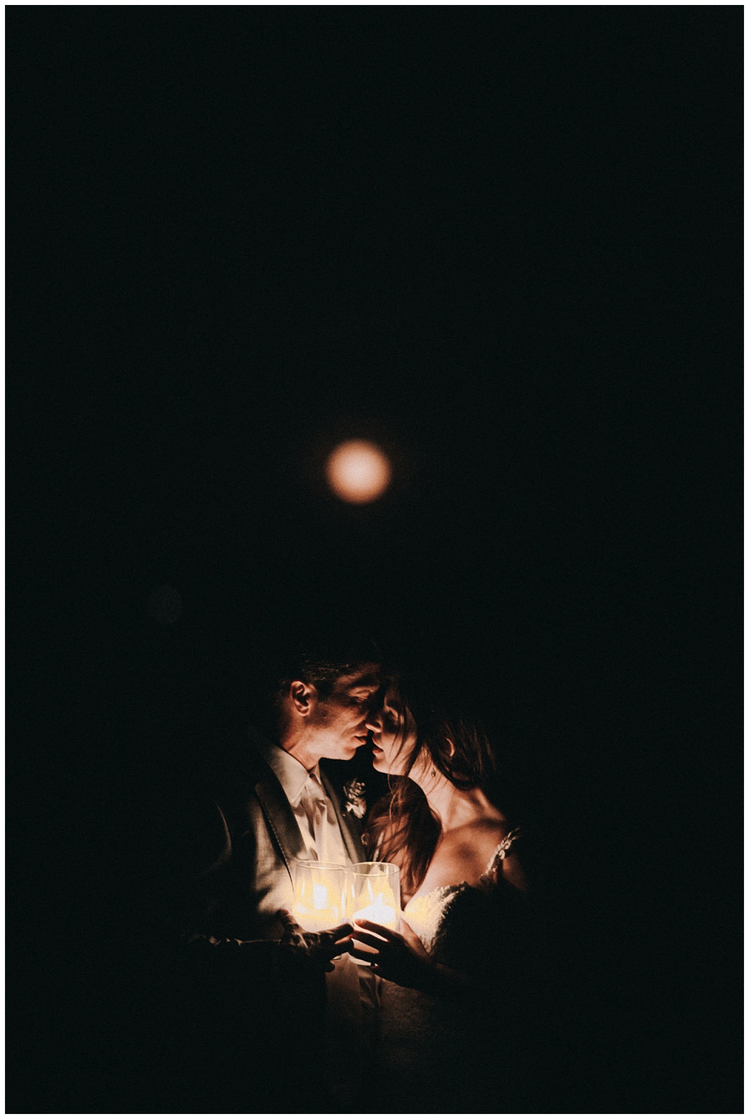 A couple kisses under the strawberry moon