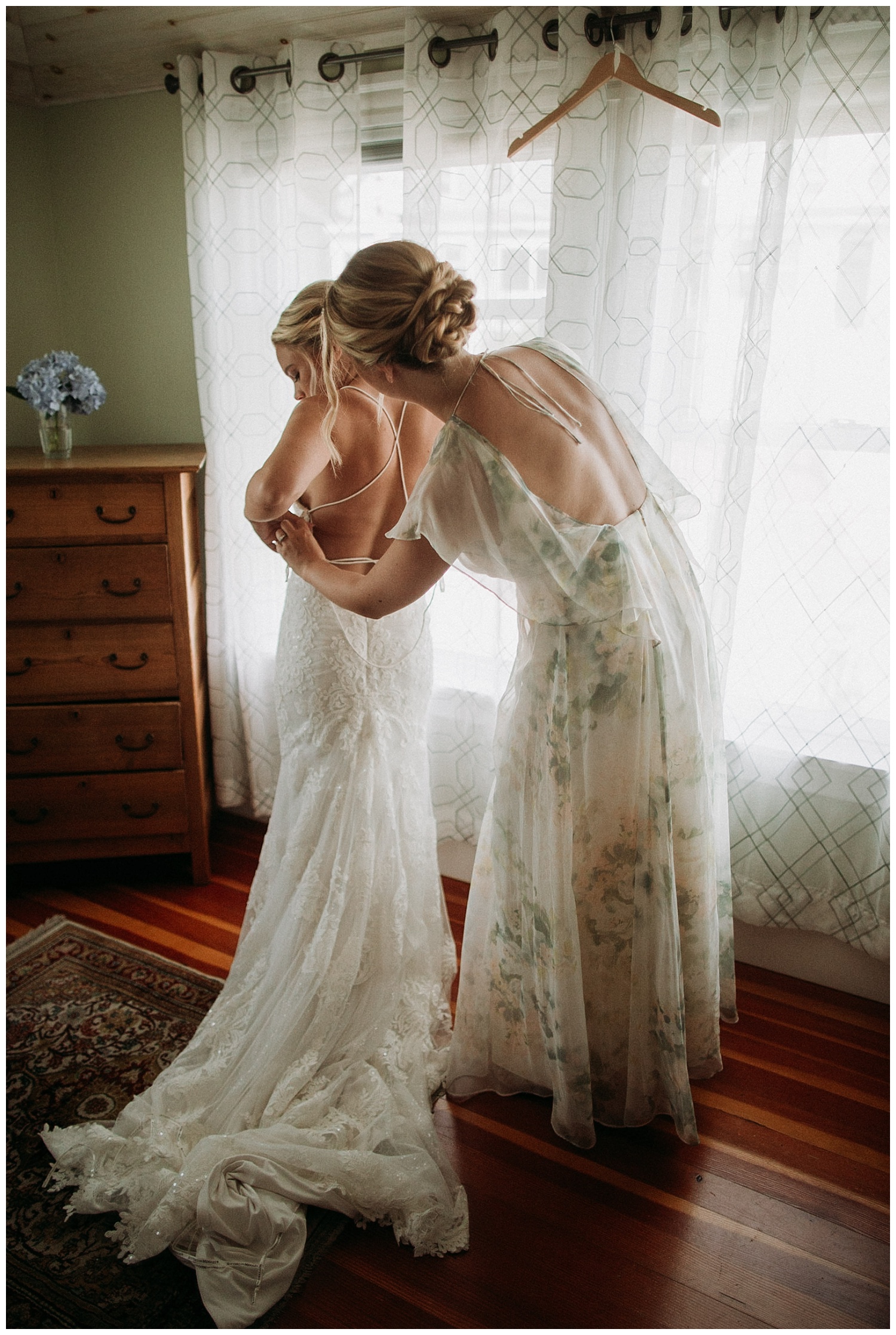 a bridesmaid helps a bride get ready