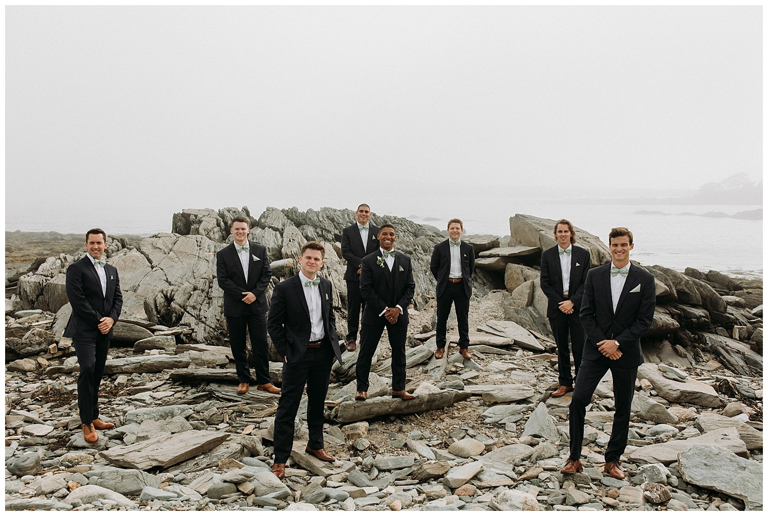 groomsmen pose on the beach on Peaks Island