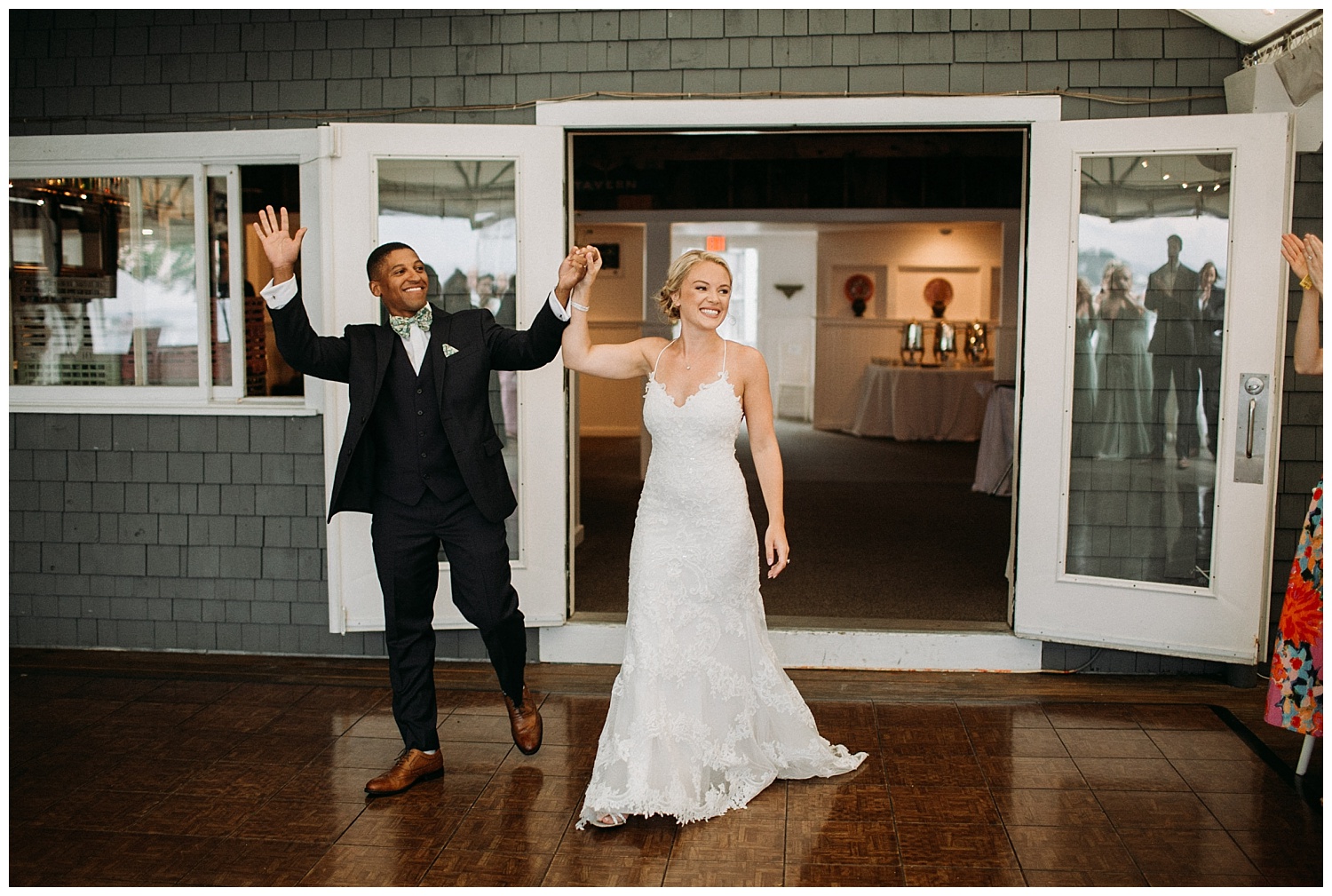 a couple makes their entrance into a wedding reception