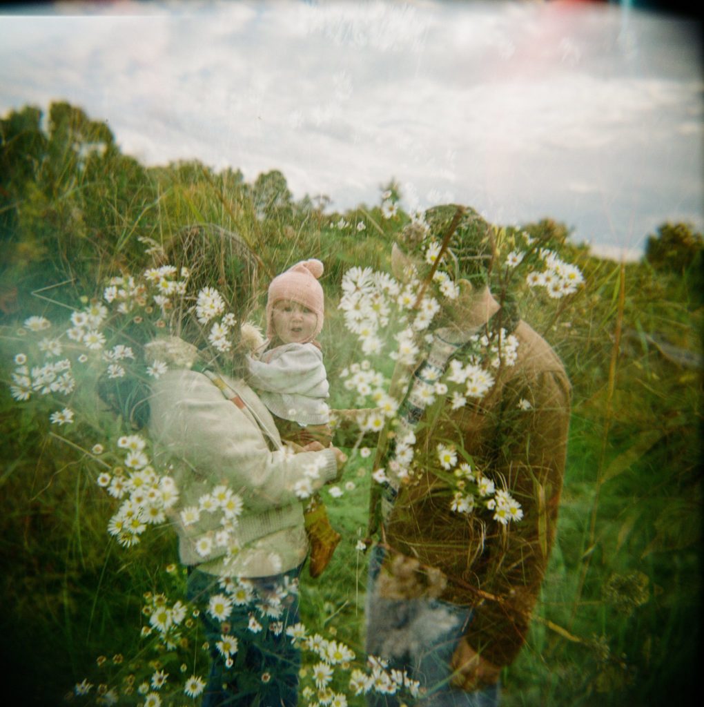 a double exposure of flowers and a family taken on film