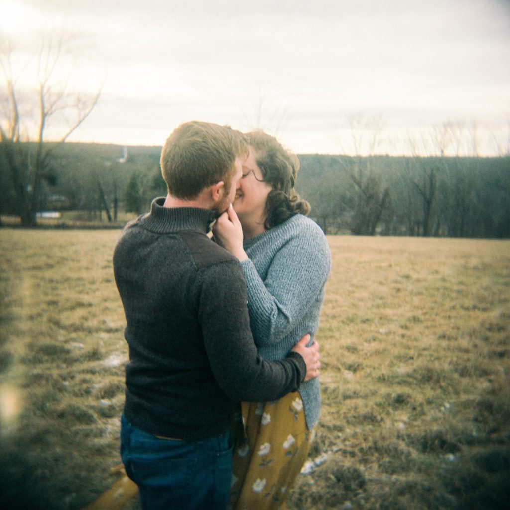Massachusetts couple kisses outdoors