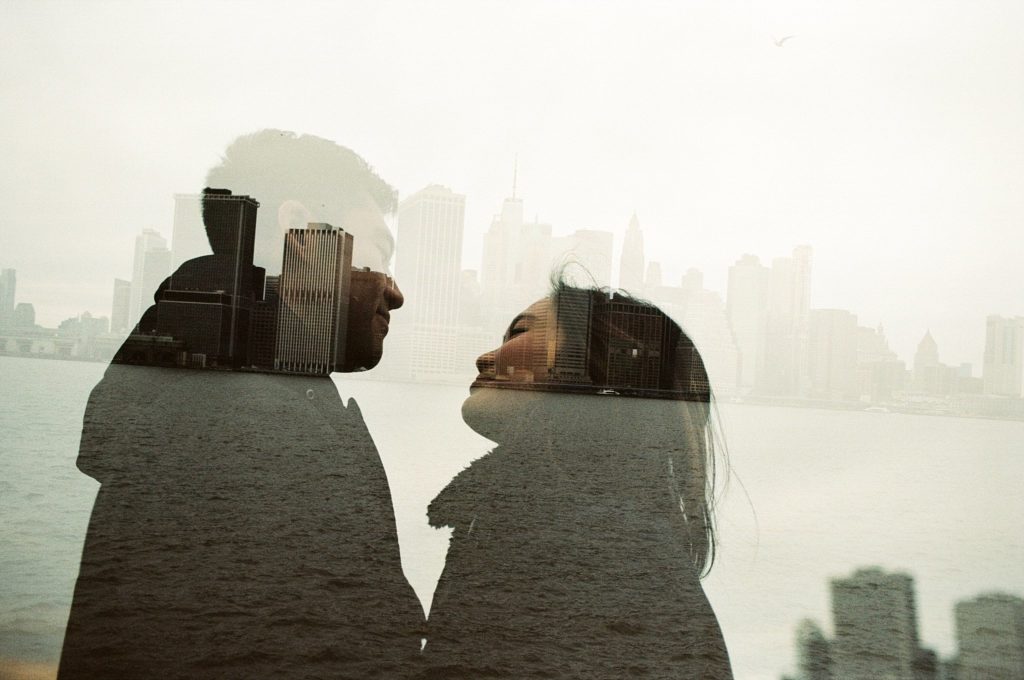 Film double exposure of Brooklyn couple against New York skyline