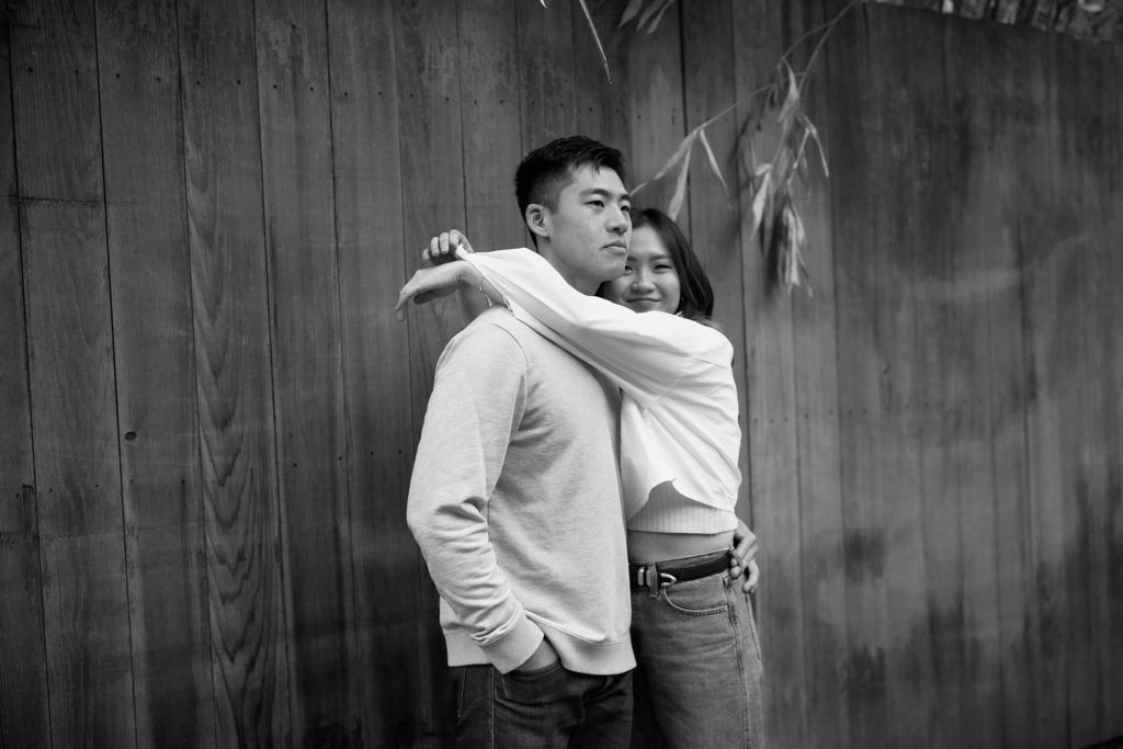 Black and white film photo of couple in loving embrace
