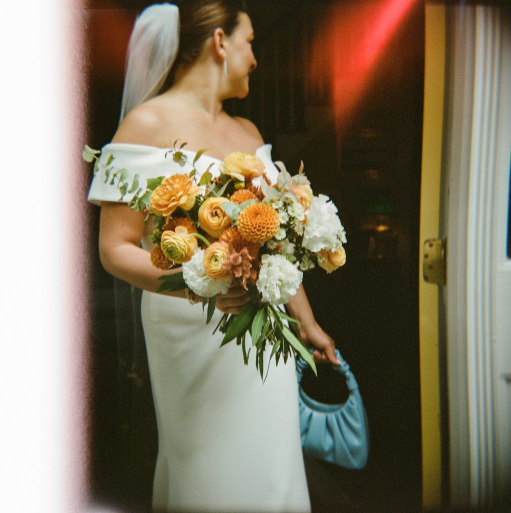 Bride holds her bouquet while getting ready for her modern wedding