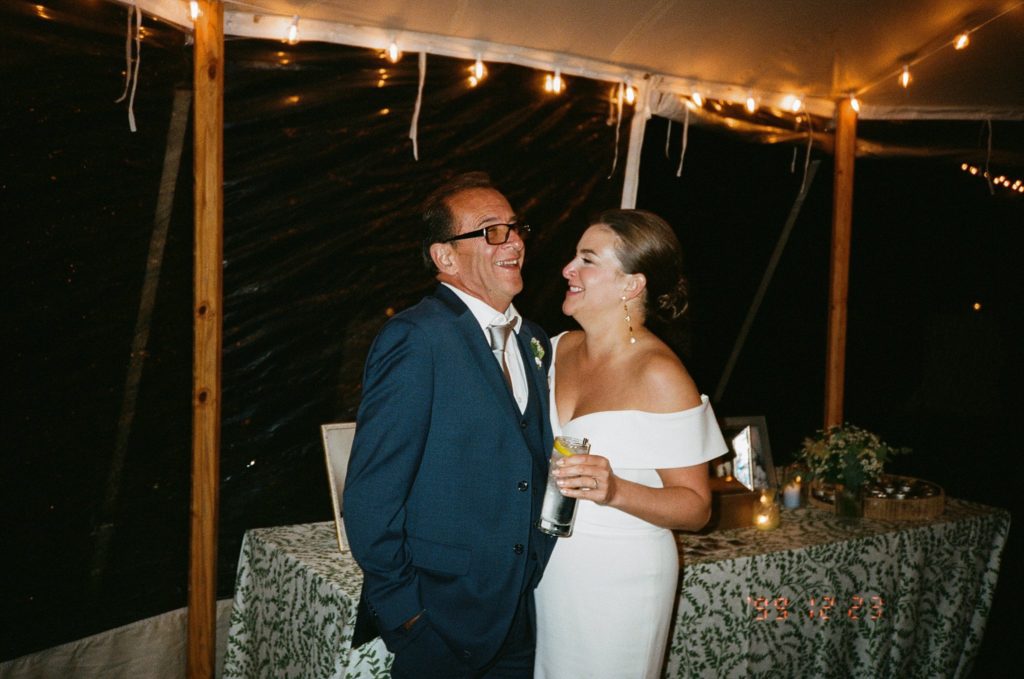 Bride laughs with her father at her modern wedding