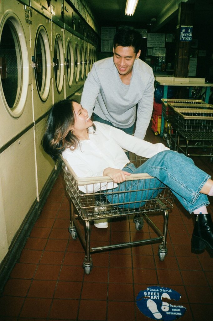 New York couple to be wed laughs together as they run around a laundromat