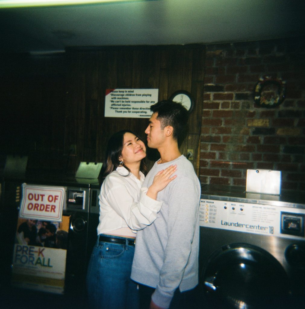 Film photo of engaged couple embracing