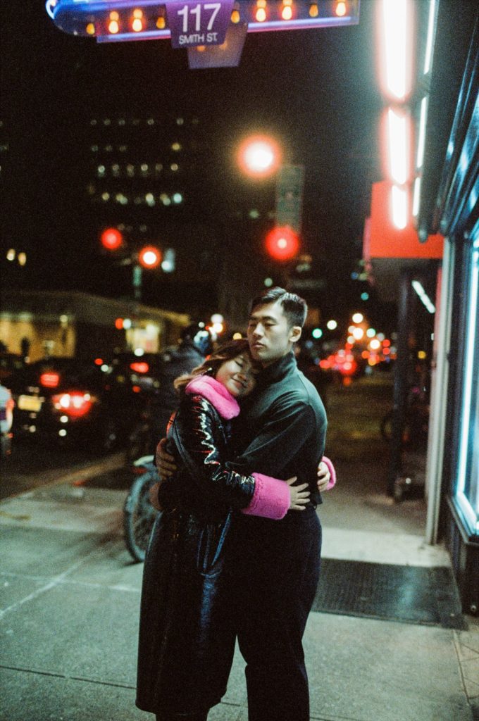 New York couple hugs amid the city lights