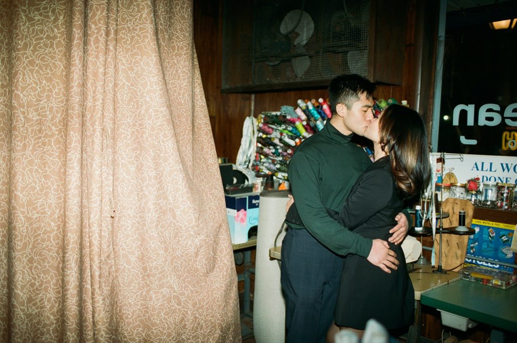 Film photo of kissing couple celebrating their engagement