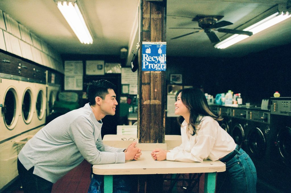 Couple look at each other on either sides of a table, shown symmetrically on film