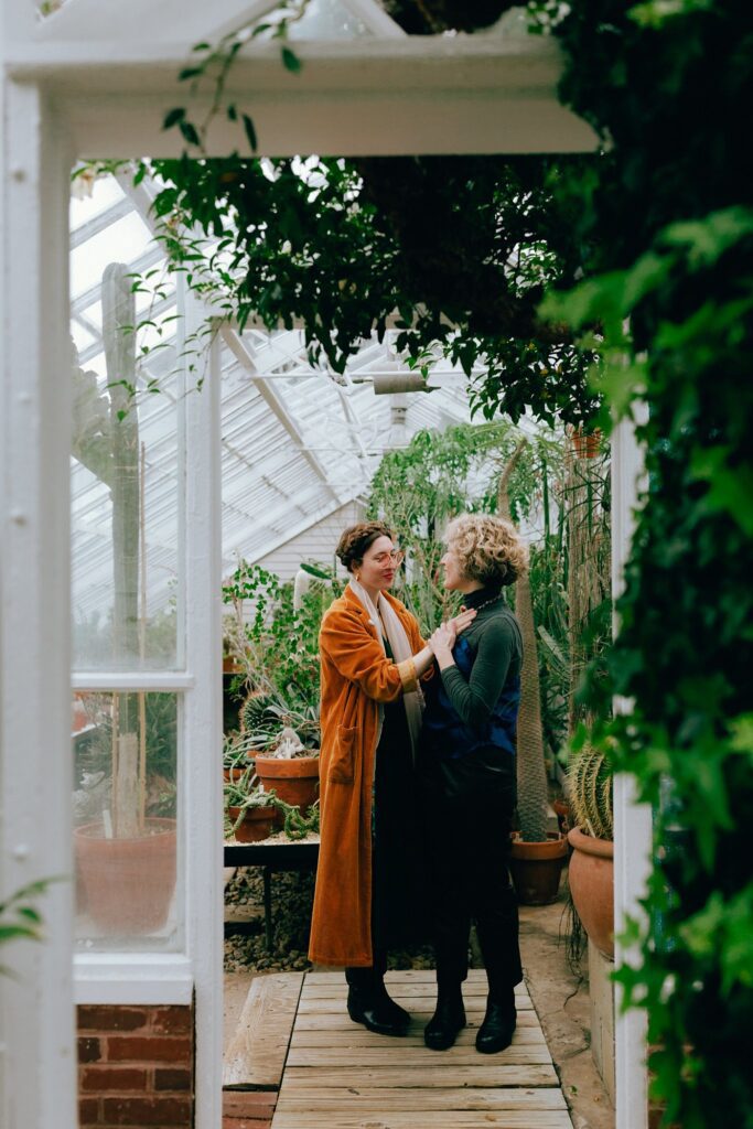 Film portrait of two women celebrating their engagement together inside a western Massachusetts greenhouse