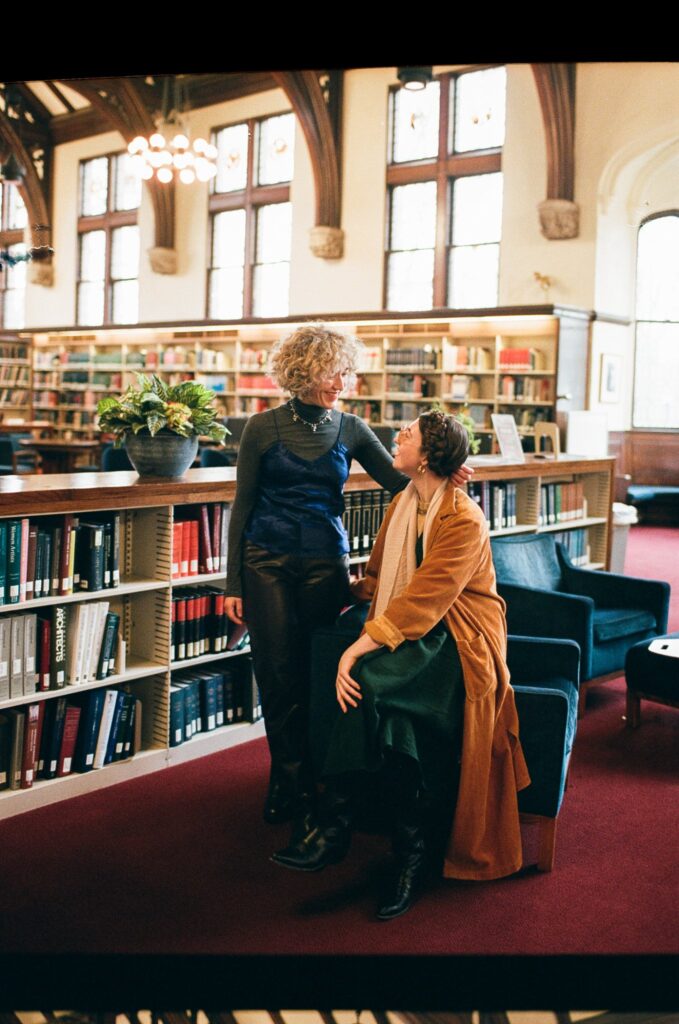Massachusetts couple looks at each other lovingly inside a library