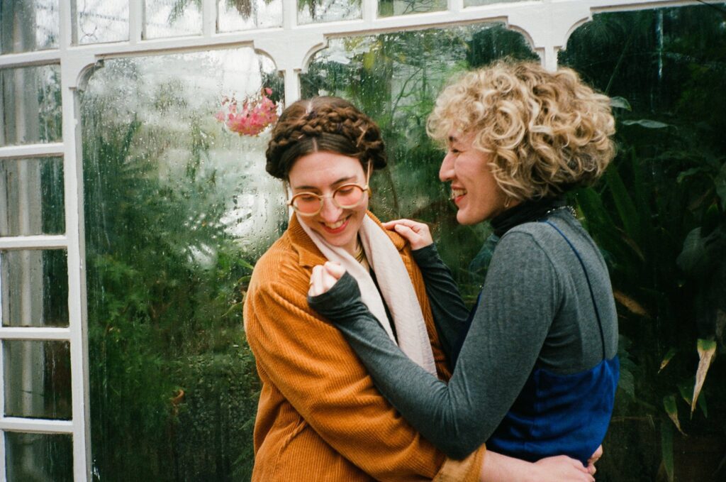 Film photograph of engaged couple hugging and smiling together
