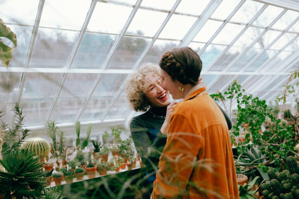 Film photograph of engaged couple laughing together amid succulents