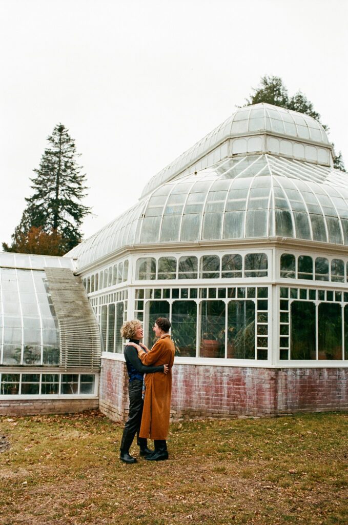 Couple embraces lovingly outside of Berkshires greenhouse