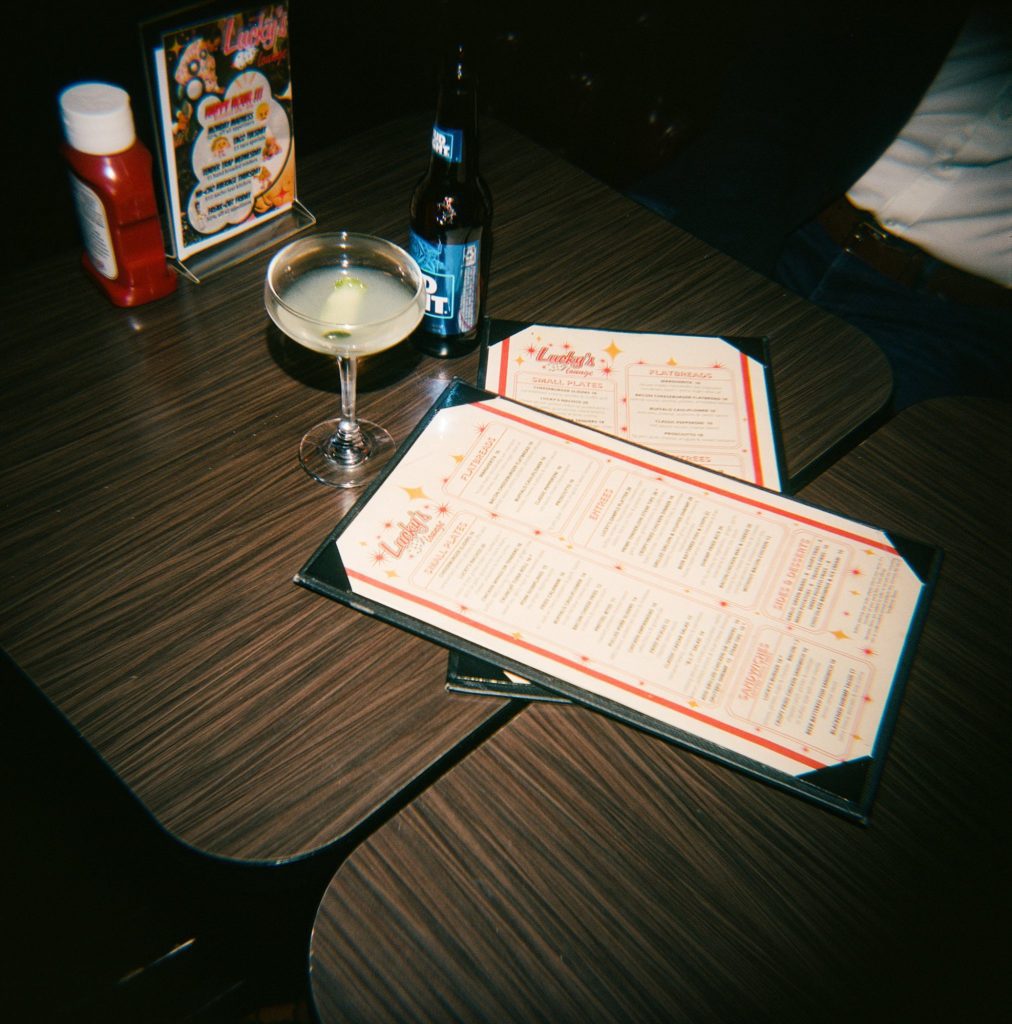 Film photograph of drinks and menus in vintage Boston bar