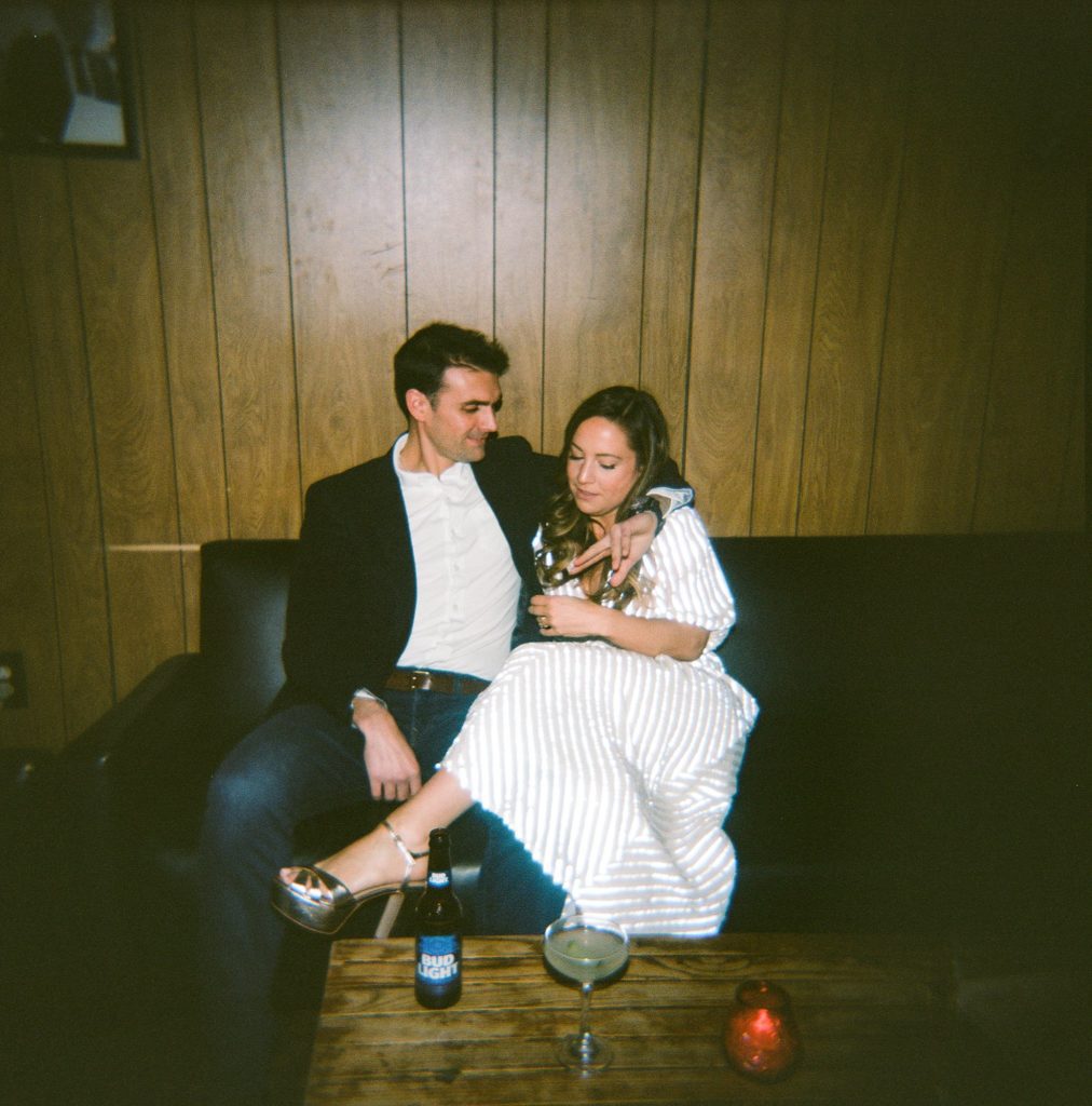 Film photograph of newly engaged couple sitting together and enjoying each other's company