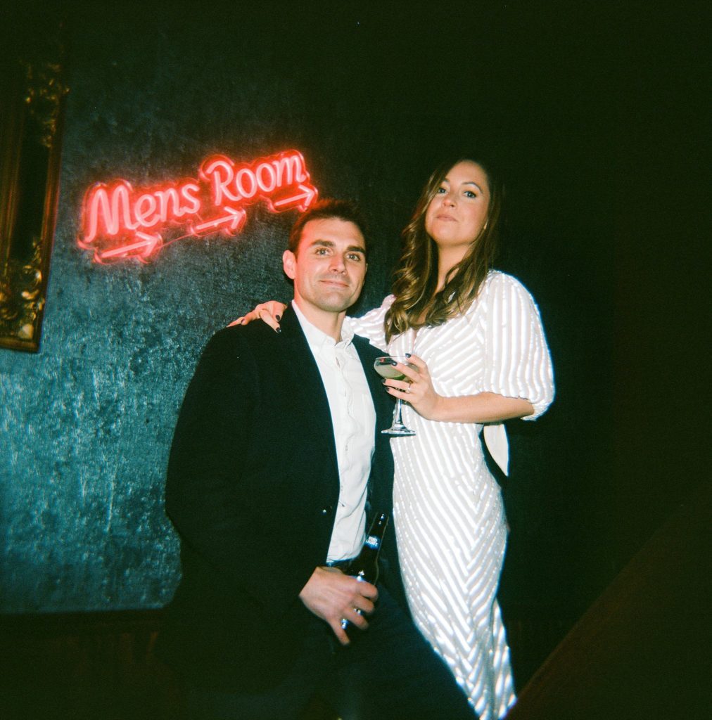 Boston Seaport couple pose inside their favorite bar