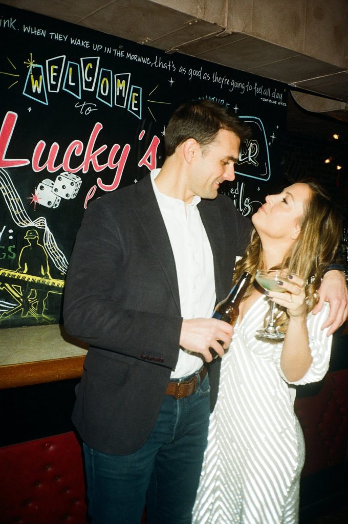 Direct flash film photo of man and woman celebrating engagement