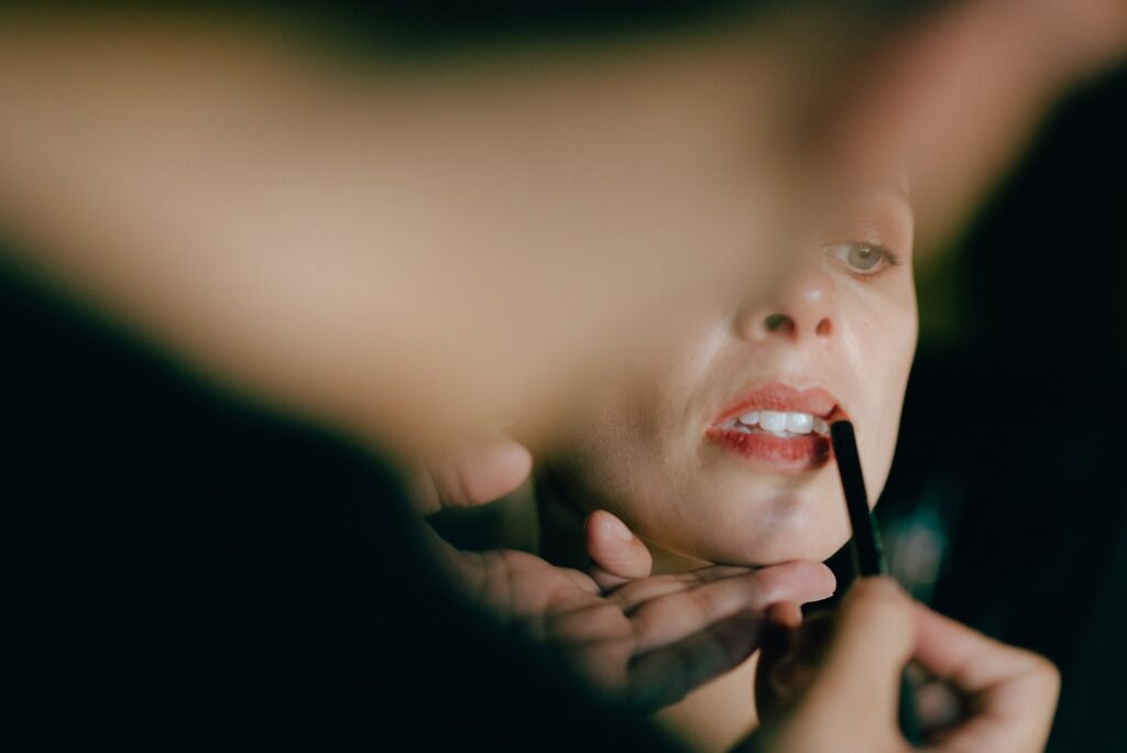 Film photograph of woman having makeup applied on day of her wedding