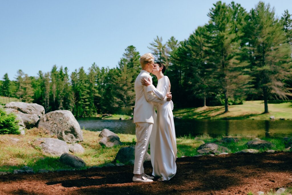 Brides embrace and kiss on the day of their luxury wedding