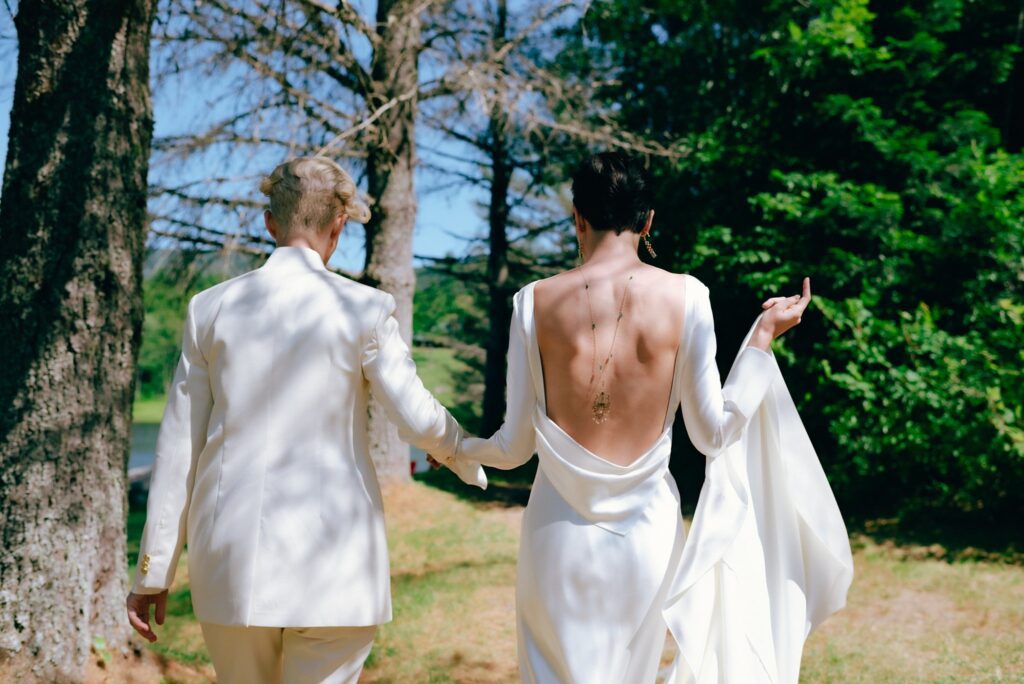 Brides walk towards ceremony space, captured on film