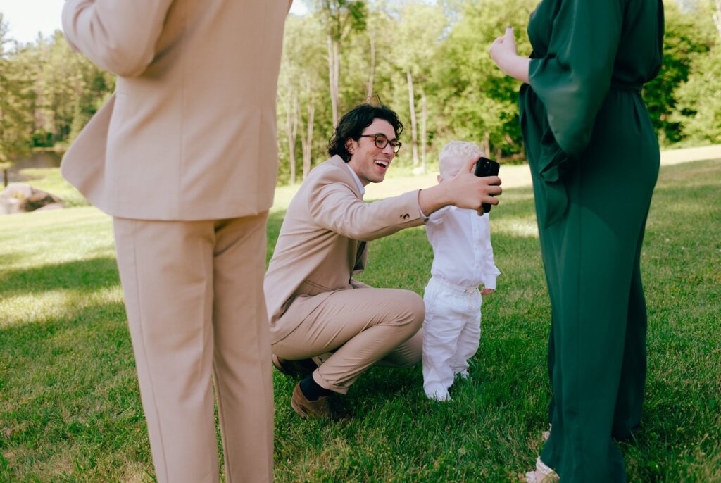 Guests smile and pose with children at upstate NY wedding