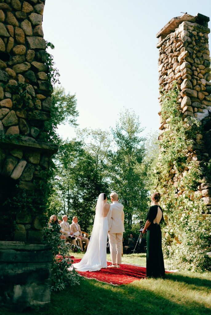 New York couple stands before their wedding guests at outdoor altar