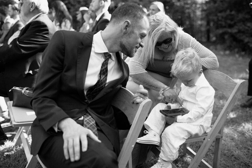 Guests smile over a small child at an upstate New York wedding ceremony