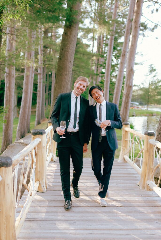 Two wedding guests smile together during cocktail hour at Adirondacks wedding