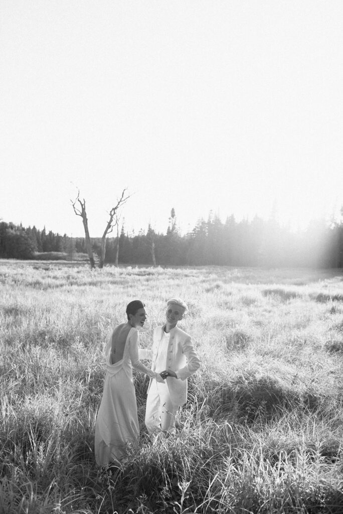 Black and white film photograph of brides in upstate New York field