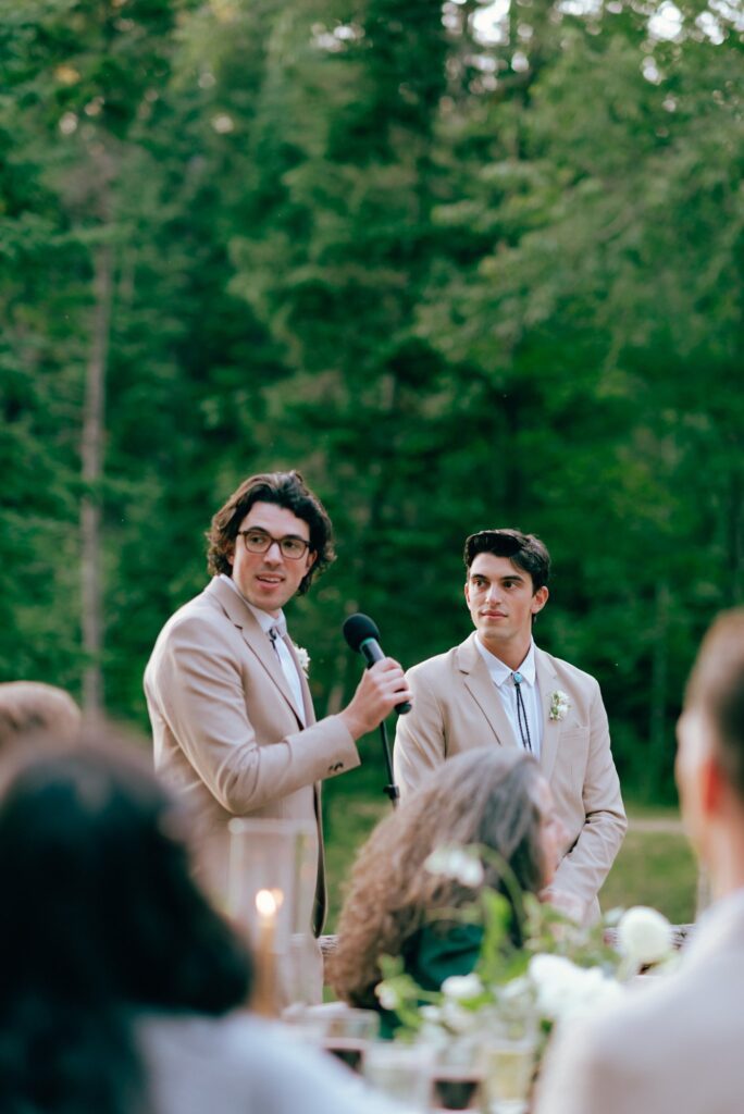 Guests give speeches at bohemian wedding