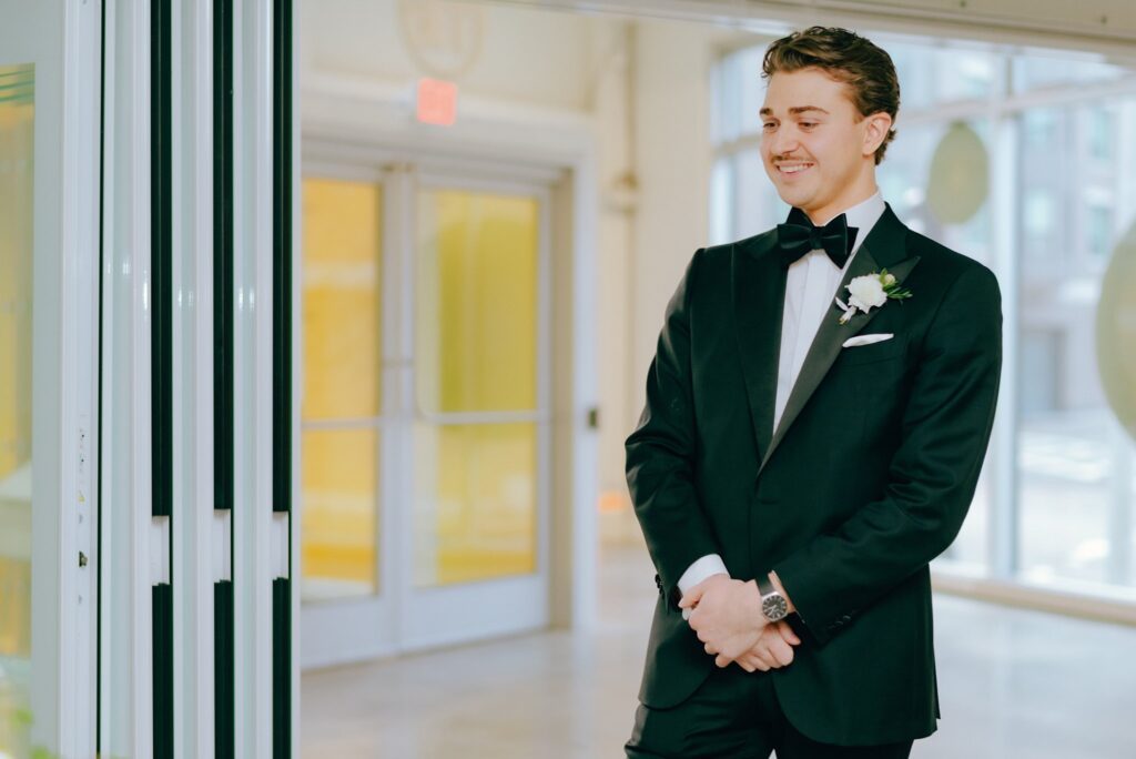 Documentary style photo of groom before wedding