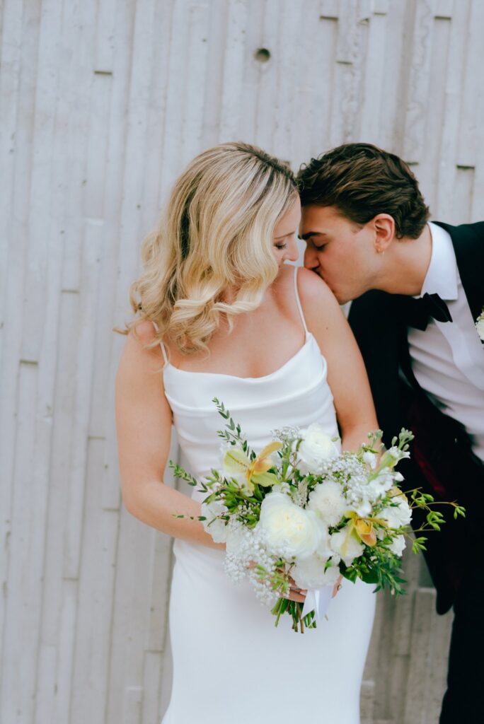Film photograph of groom kissing bride