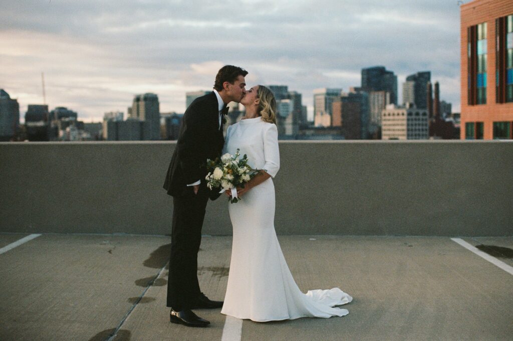 Newlyweds kiss on a Boston rooftop
