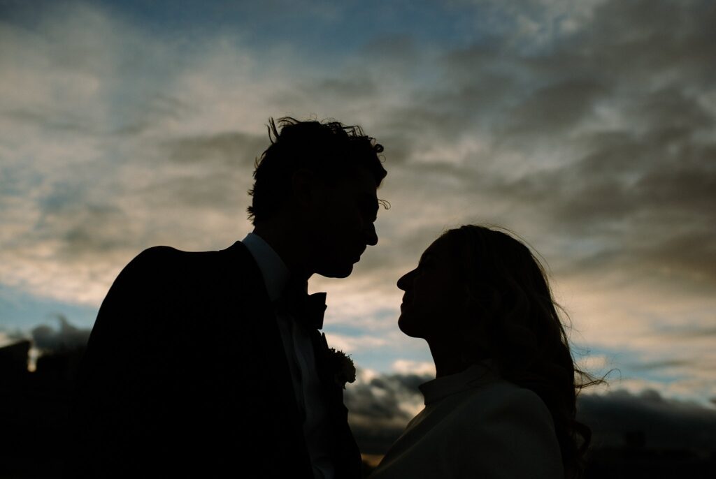 Dramatic silhouette of Boston bride and groom