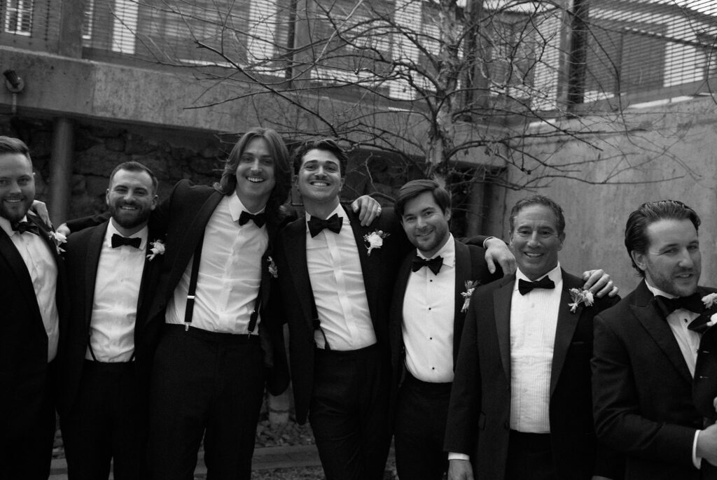 Documentary photo of groom and groomsmen in black and white