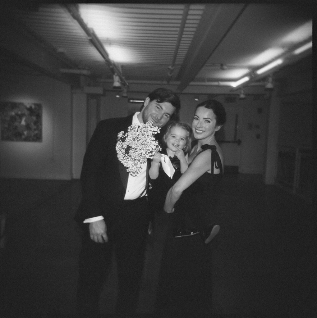 Black and white film photo of wedding guests at Artists for Humanity