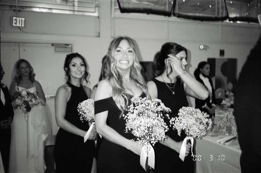 Bridesmaid smiles, captured on film in black and white