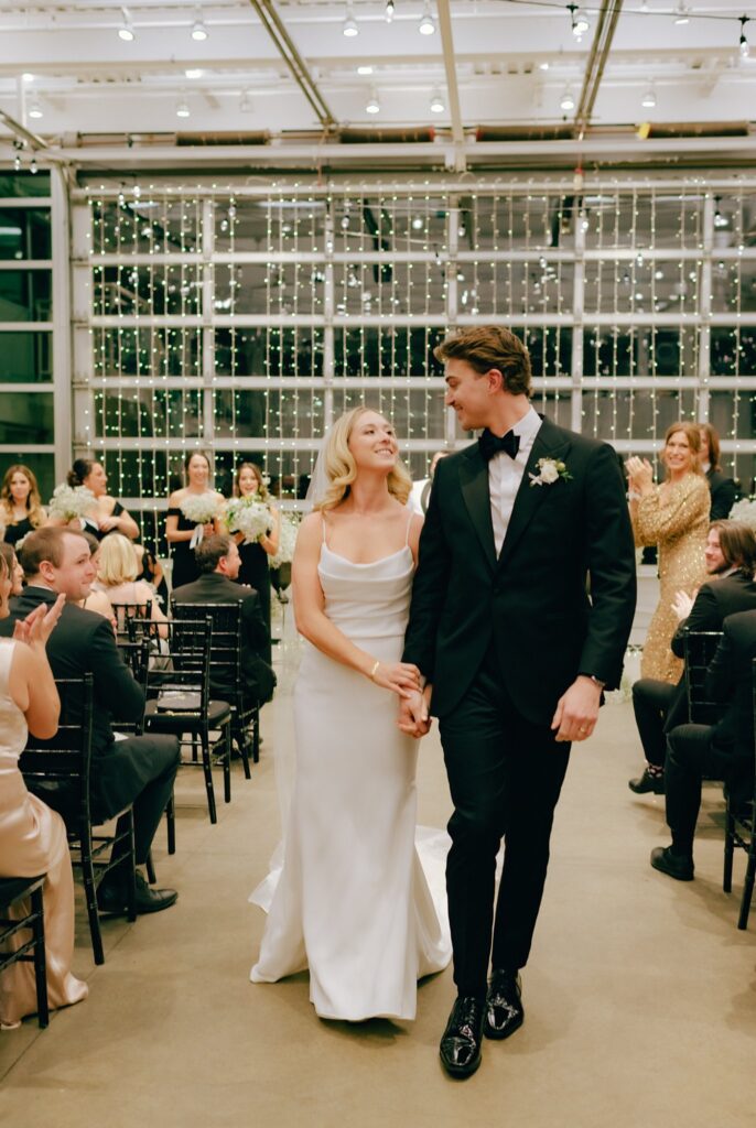 Happy newlyweds walk back up the aisle after getting married at Artists for Humanity