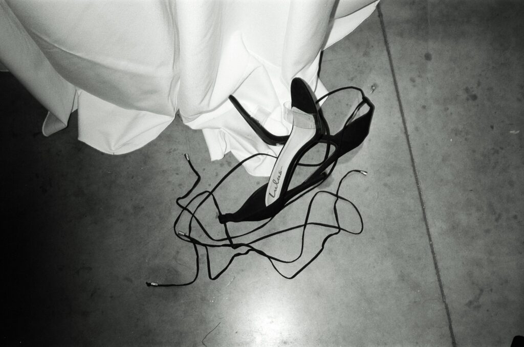Film photograph of wedding shoes cast off on the dance floor