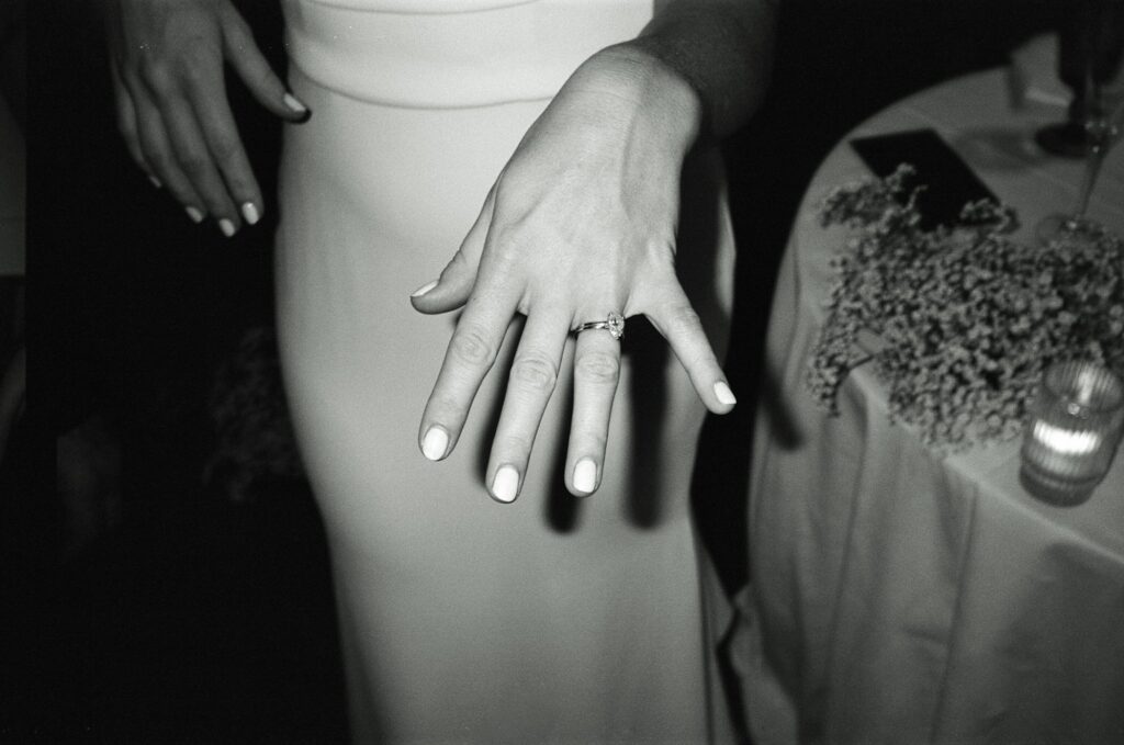 Film photograph of bride's wedding ring in black and white