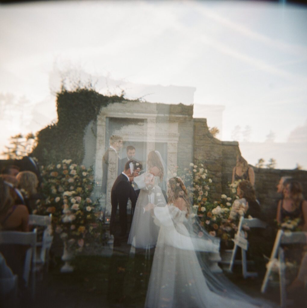 Double exposure of bride and groom exchanging vows at Shepherd's Run ceremony space