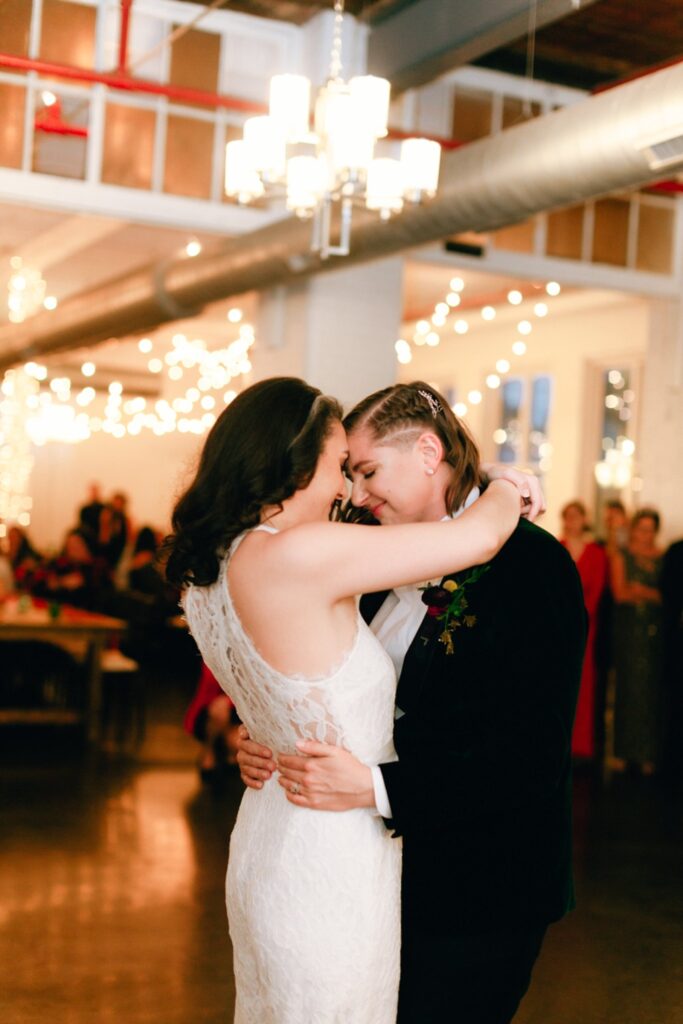 brides embrace during their first dance