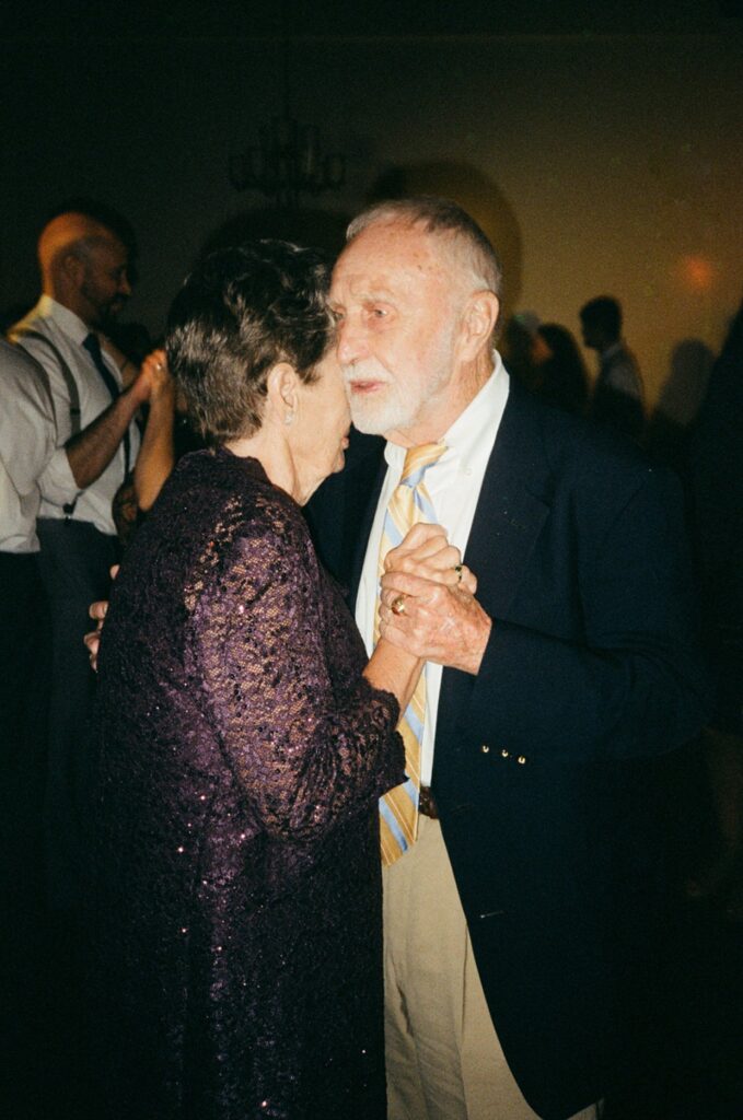 grandparents dance during their granddaughter's wedding reception